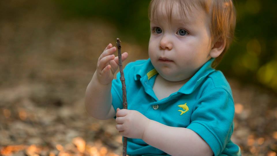 toddler playing with stick